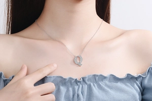 Detailed close-up of capital letter Q pendant with sparkling pave set white zircons