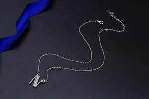 Macro detail of silver S925 letter N pendant necklace with sparkling cubic zirconia stones