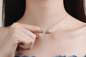 Close-up of silver V-shaped pendant necklace with cubic zirconia micro-pave setting