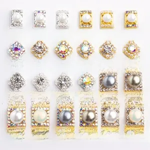 Detailed grid of crystal rhinestone nail art charms with pearls in gold and silver bases