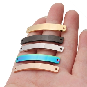 Polished curved stainless steel bar connectors in five metallic finishes held in hand
