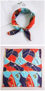 Detail of silk scarf showing vintage harness chain print and styling knot on white background