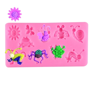 Pink silicone mold with flower and insect shapes for DIY cake decorating and baking