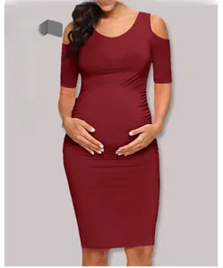Close-up of red off-shoulder maternity pencil dress with ruched side details and round neck