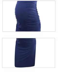 Detail view of the side ruching and hem of this solid navy maternity crewneck dress