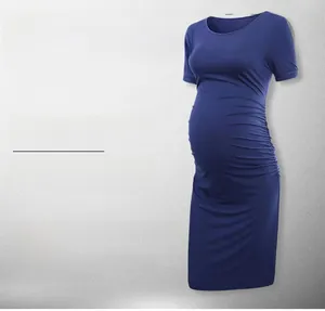 Detail showing side ruching on a navy blue maternity dress for a comfortable fit