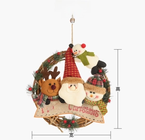 Detail of Christmas rattan wreath with Santa, snowman, and reindeer plush ornaments