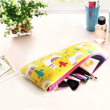 Detail of yellow cosmetic bag with alpaca prints and organized makeup tools inside