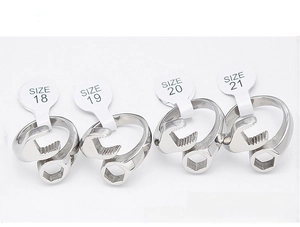 Macro view of four wrench-shaped steel rings in sizes 18 to 21 on white background