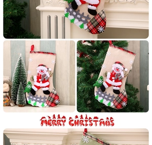 Detailed view of burlap Christmas stockings featuring Santa applique and plaid trim decor