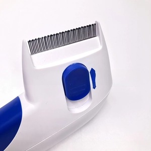 Detail view of the blue slider switch for comb and eject functions on the pet grooming tool