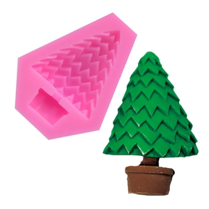 Detail view of pink silicone mold with a finished 3D green Christmas tree candle