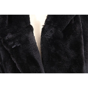 Close-up of black faux fur winter coat featuring a functional hidden hook-and-eye fastener