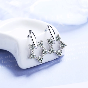 Elegant star shaped silver earrings with shimmering cubic zirconia in macro photography