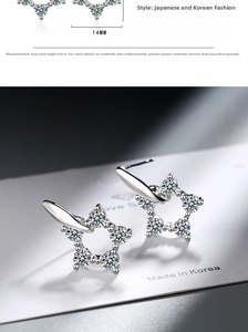 Close-up showing a 14mm star-shaped silver stud earring with sparkling cubic zirconia crystals
