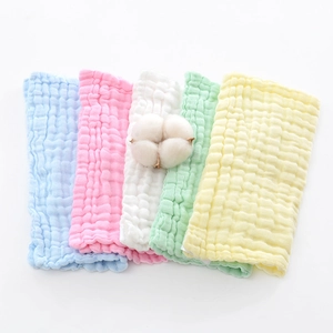 Five-color stack of cotton muslin baby washcloths with soft bubble texture and cotton flower