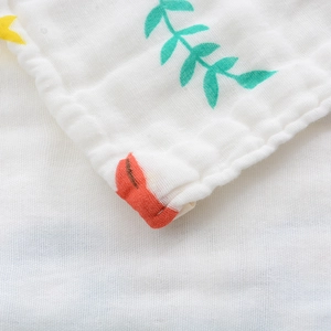 Macro detail of breathable six-layer cotton gauze baby towel with leaf pattern