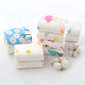 Close-up of 6-layer cotton baby towels featuring cute cartoon prints and soft texture