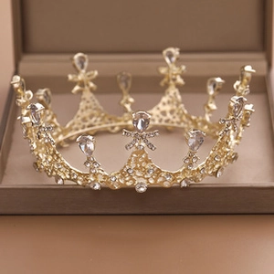 Detailed close-up of a sparkling gold rhinestone bridal crown in a jewelry box