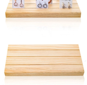 Detail view of wooden earring display stand with slots for cards and jewelry