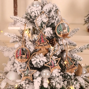 3D hollow wooden Christmas pendants with reindeer and forest scenes on a festive tree