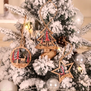 Hollow laser-cut wooden Christmas ornaments with reindeer and tree designs on white tree