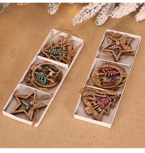 Detail of wooden 3D Christmas ornaments with reindeer patterns in a white gift box