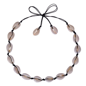 Detailed view of hand-knotted natural white cowrie shell necklace on a black string