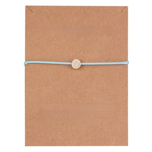 Detail of light blue woven wish bracelet with a gold textured disc on gift card