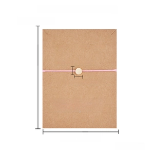 Pink braided heart butterfly wish bracelet on brown card showing adjustable sizing details