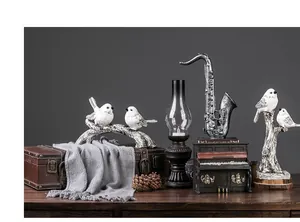 Retro saxophone and piano miniature ornaments with bird sculptures on vintage suitcases