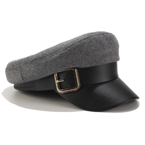 Detailed side view of two-tone newsboy hat with grey wool top and black PU leather brim