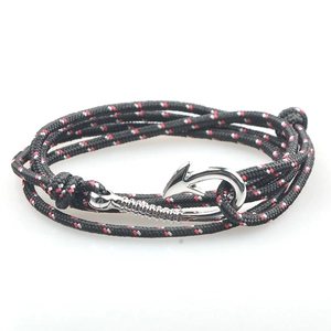 Close-up of triple-wrap braided anchor bracelets in black, red, and white with silver hook