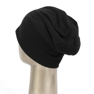Close-up of black thin knit beanie showing texture and slouchy fit on model head