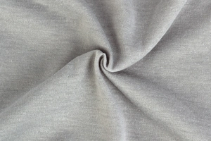 Close-up of light gray knit fabric texture showing soft folds and material detail