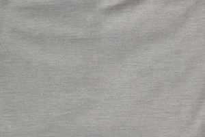 Macro texture detail of fine grey knitted fabric for a thin double-layer beanie cap