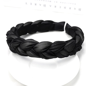 Detail of black braided headband with silky fabric texture and thick three-strand weave