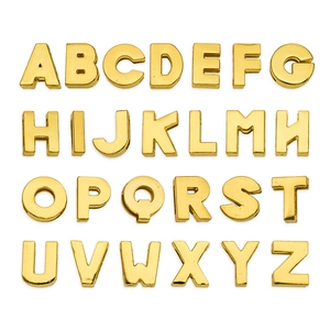 Collection of gold A-Z alphabet slide charms for DIY jewelry and keychains on white background