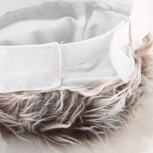 Detail of adjustable velcro strap and realistic synthetic hair on white docker cap