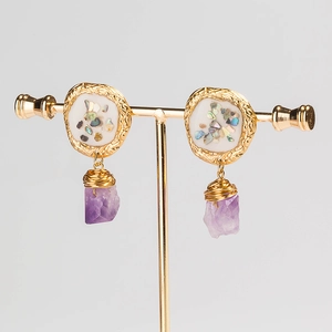Bohemian gold earrings featuring colorful crushed shells and purple amethyst pendants