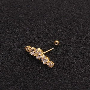 Gold stainless steel star stud earring with clear cubic zirconia on black background
