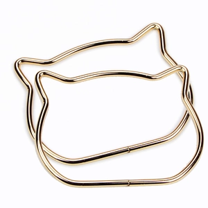 Pair of gold metal cat ear handles for handmade bags with shiny polished finish