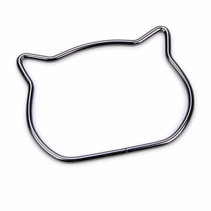 Macro view of gunmetal alloy cat-shaped metal handle for handbags with a glossy finish
