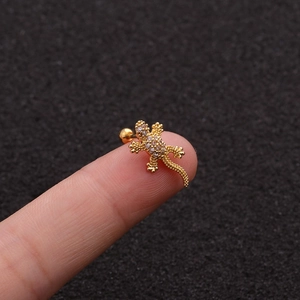 Exquisite gold gecko stud earrings with sparkling cubic zirconia on a fingertip