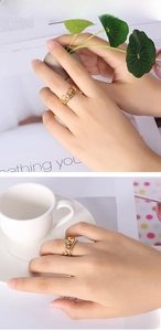 Close-up of golden crown and star ring with clear crystals on a female hand