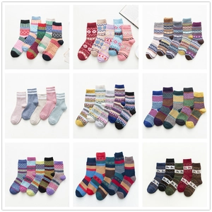 Detail showing 9 packs of winter wool blend socks with Nordic patterns and ethnic styles