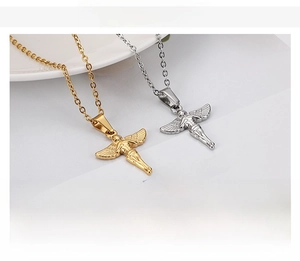 Detailed view of angel wing pendants in gold and silver finish on stainless steel chains