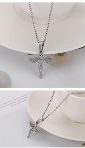 Detail view of a silver angel pendant necklace in stainless steel with wings design