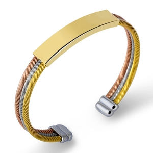 Detailed shot of triple-tone twisted steel cable bracelet in gold silver and rose gold