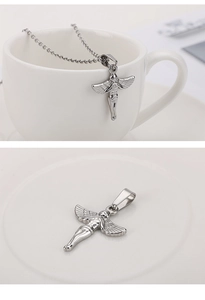 Detail of silver stainless steel angel pendant necklace on white ceramic surface